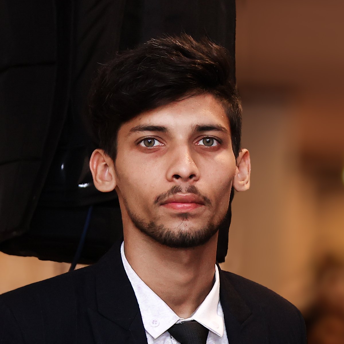 Abdul Rafay Amir, founder of RafayGen AI, in a dark suit and tie